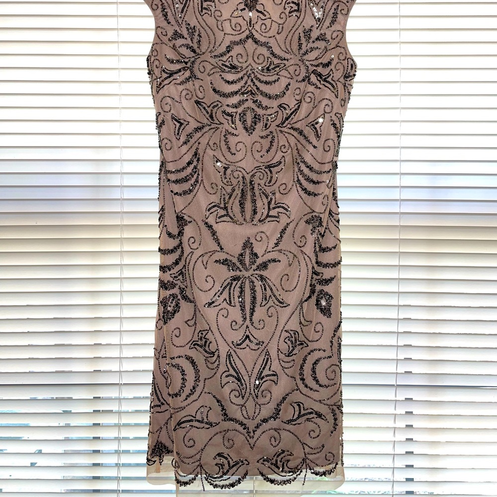 Off cream/gray color. Embellished. Very elegant. Wears well.